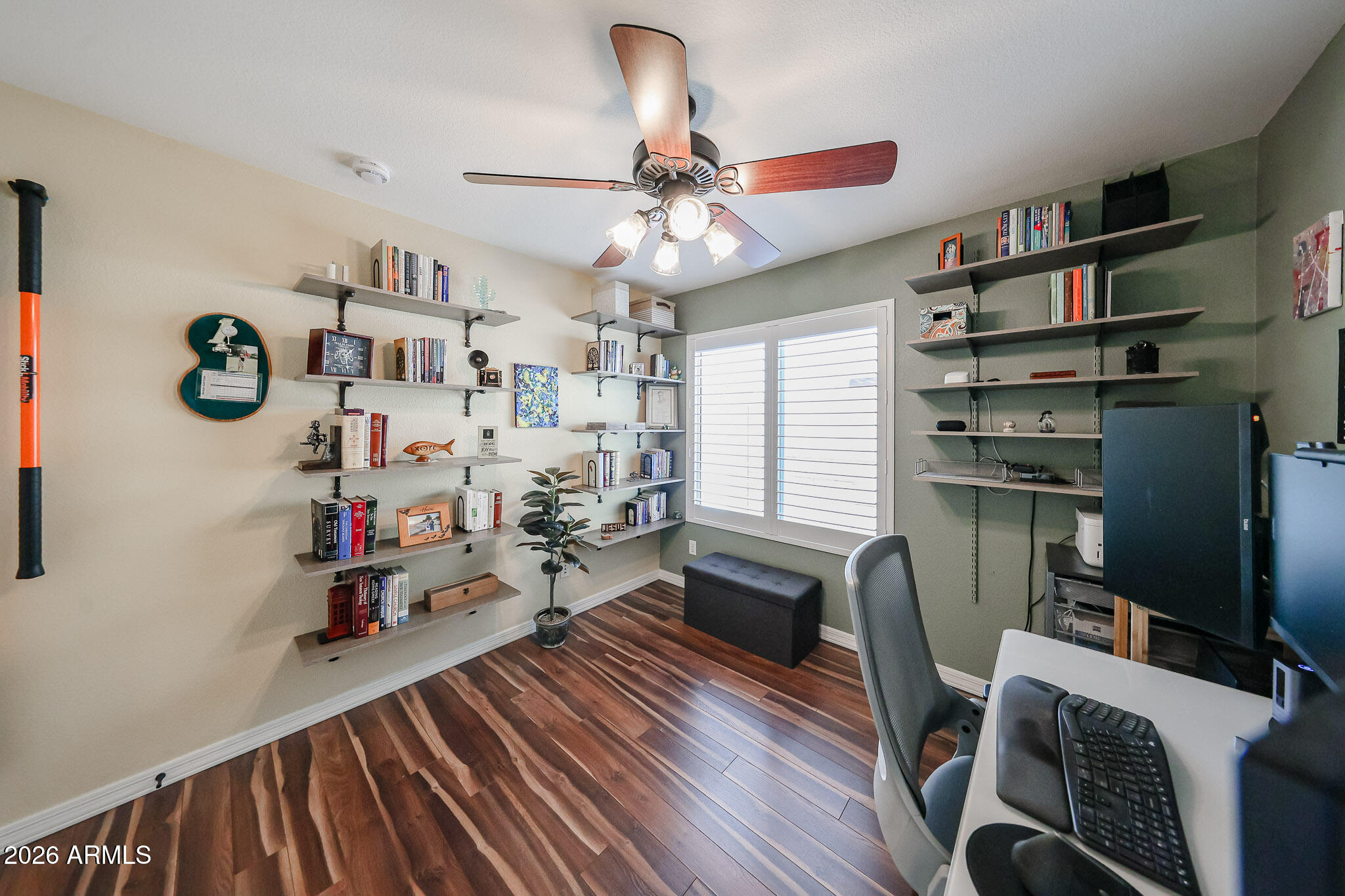 6939 West Phelps Road Peoria, AZ 85382 - Photo 19 of 29 a view of a workspace with furniture and a window