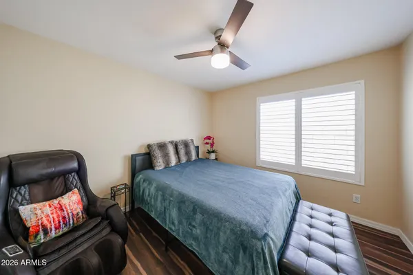 a bedroom with two beds and a chandelier