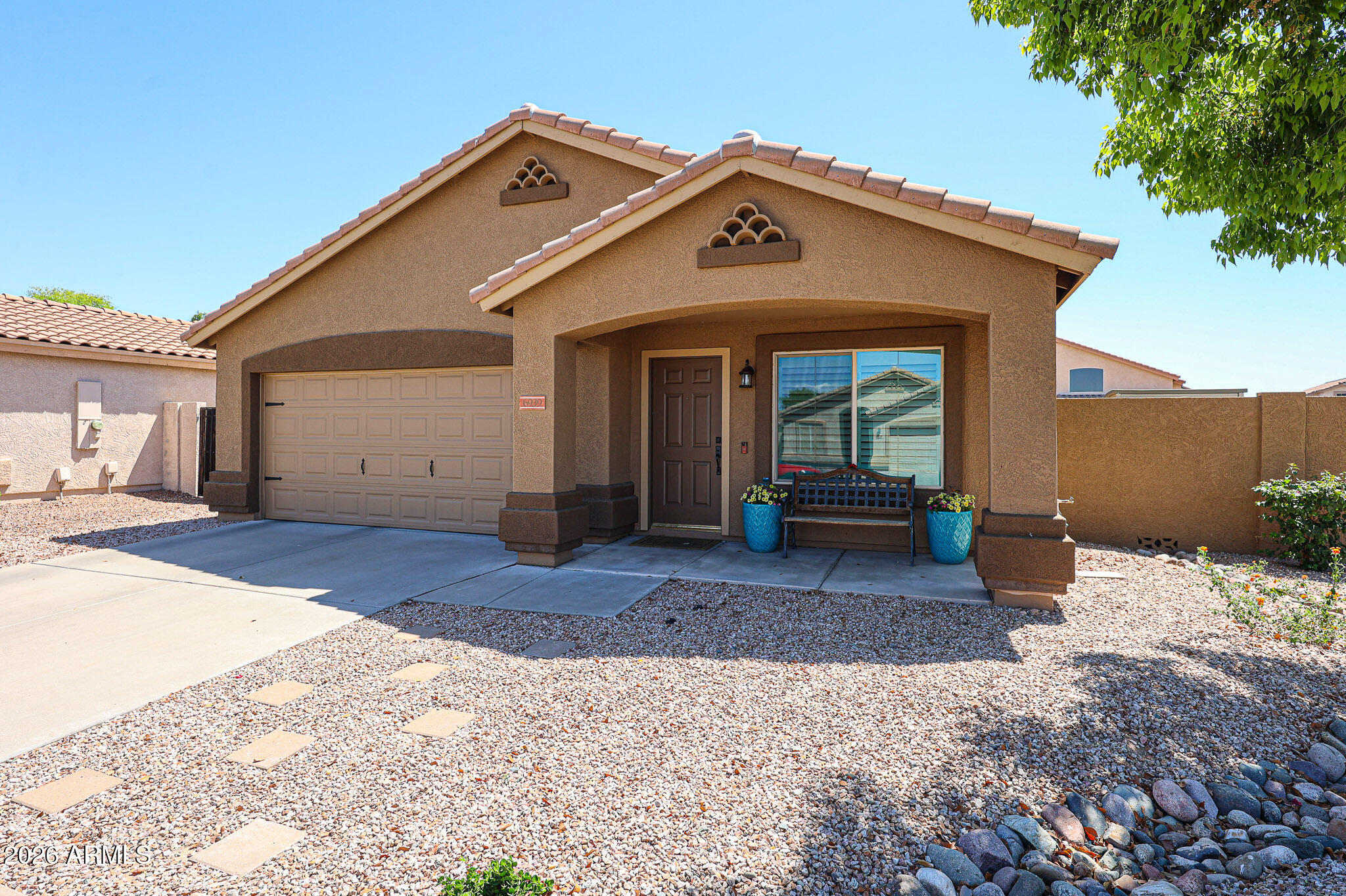 6939 West Phelps Road Peoria, AZ 85382 - Photo 2 of 29 a front view of a house with a yard