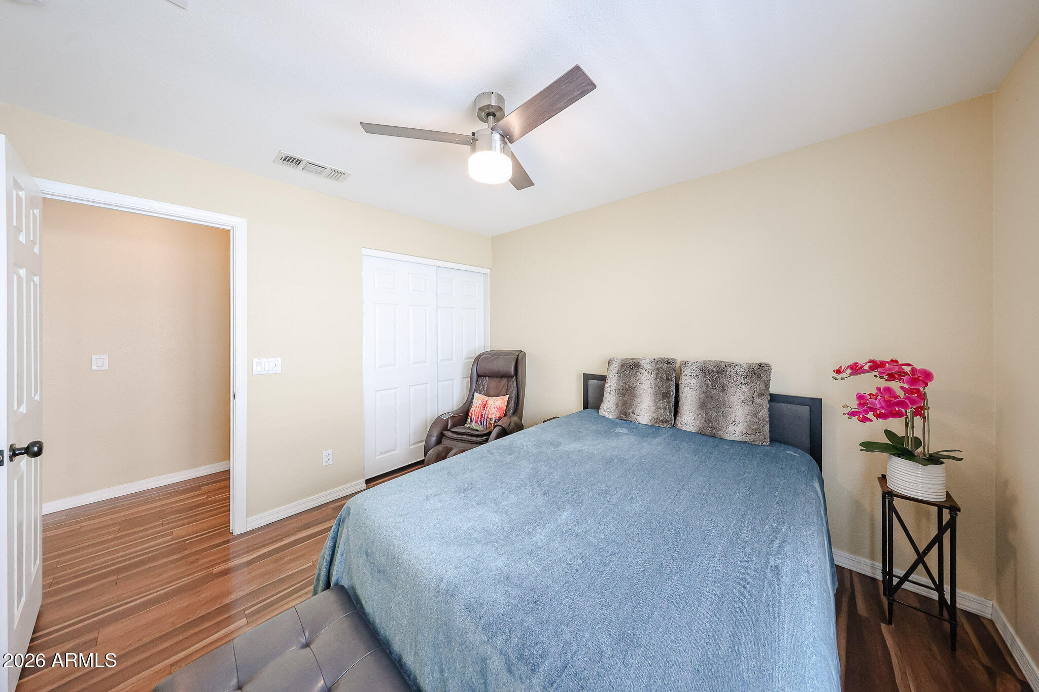 6939 West Phelps Road Peoria, AZ 85382 - Photo 21 of 29 a bedroom with a bed and wooden floor