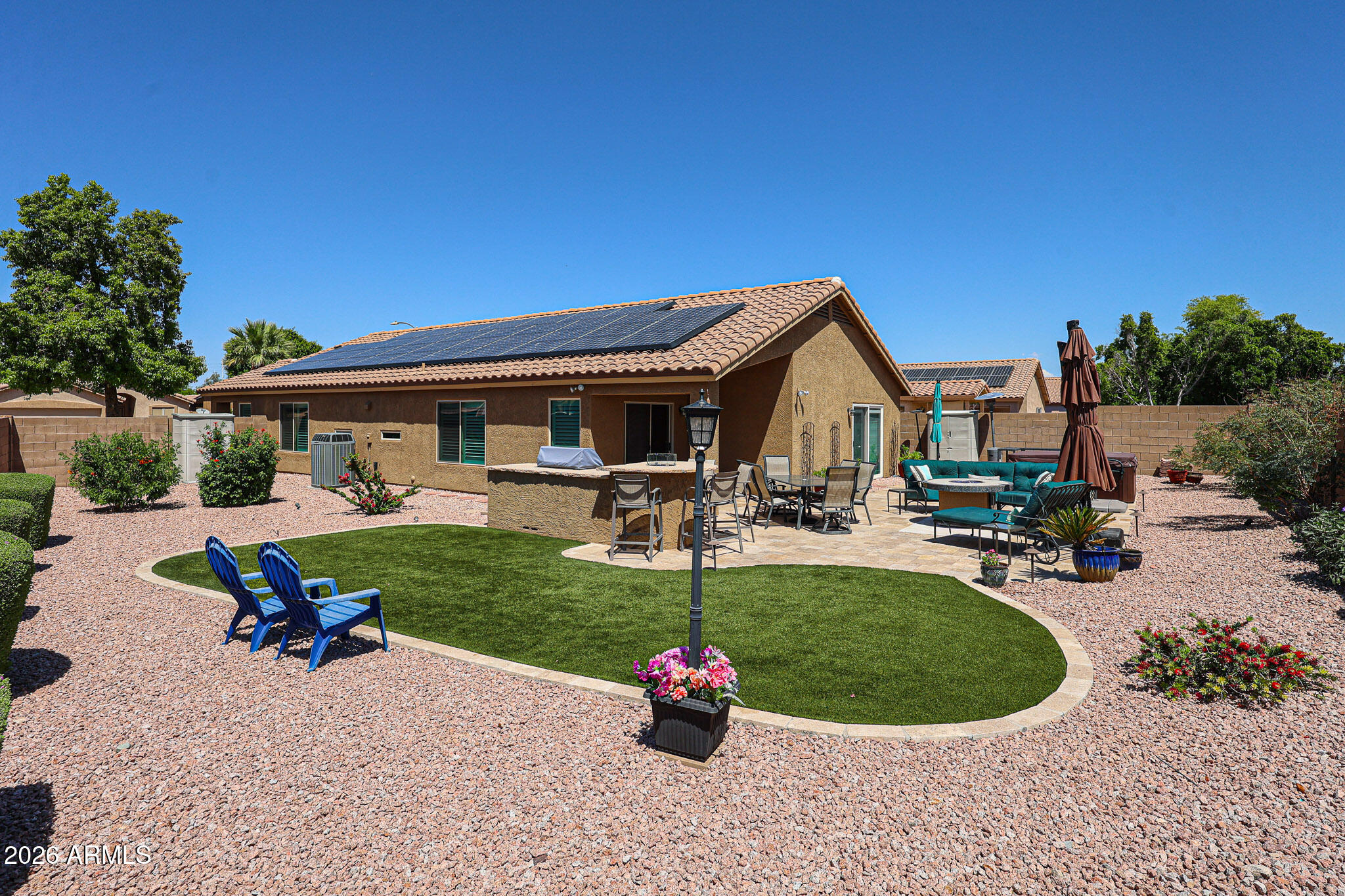 6939 West Phelps Road Peoria, AZ 85382 - Photo 22 of 29 a view of a house with backyard porch and outdoor seating