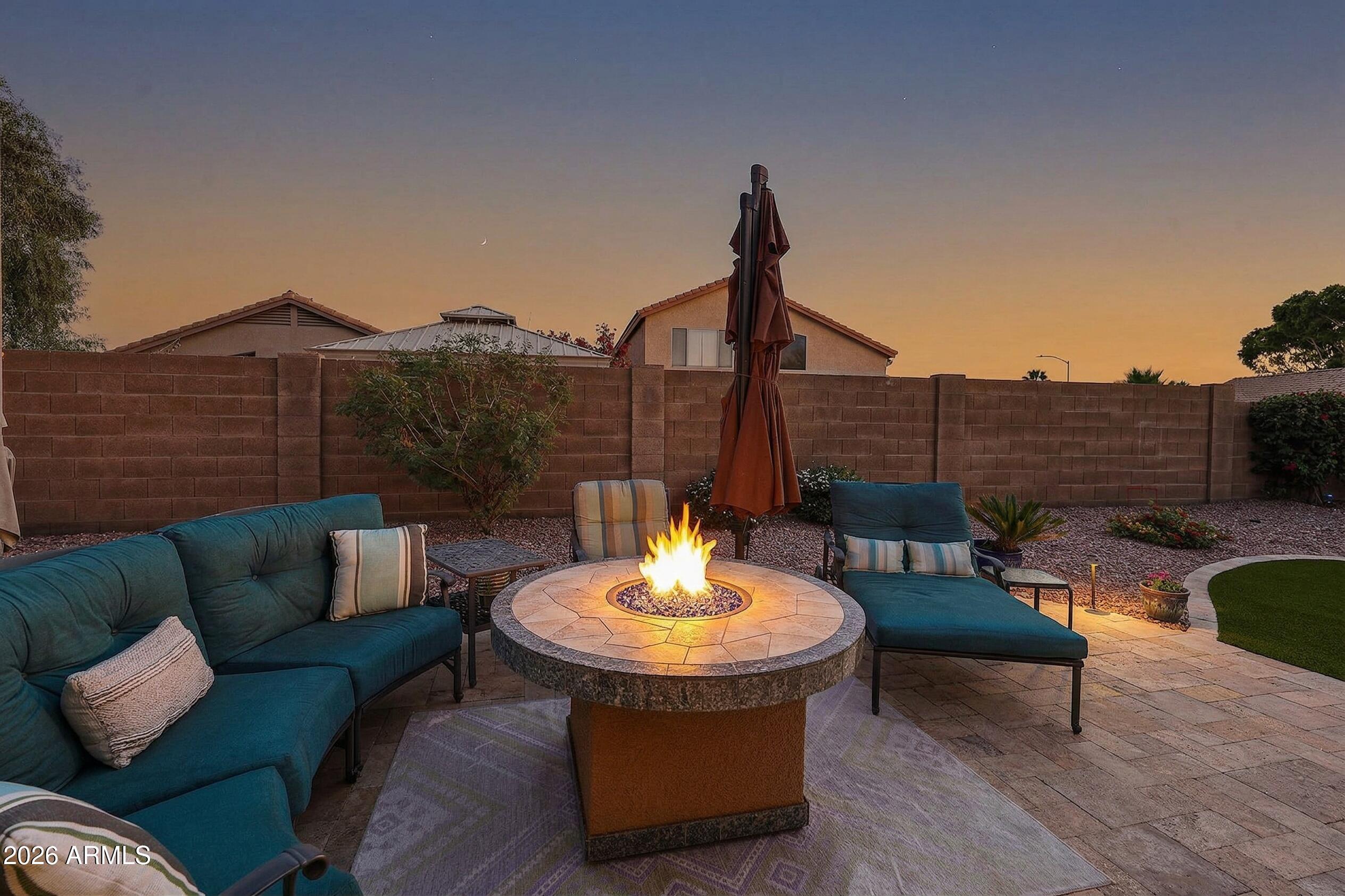6939 West Phelps Road Peoria, AZ 85382 - Photo 25 of 29 a outdoor living space with furniture and a fireplace