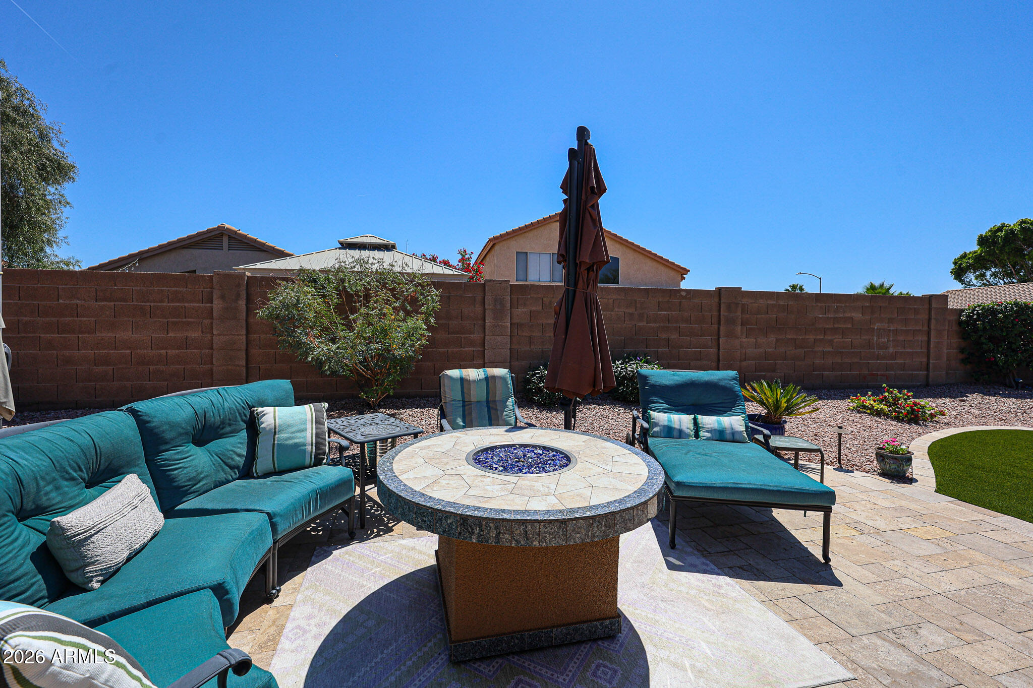 6939 West Phelps Road Peoria, AZ 85382 - Photo 26 of 29 a view of a patio with couches table and chairs with potted plants
