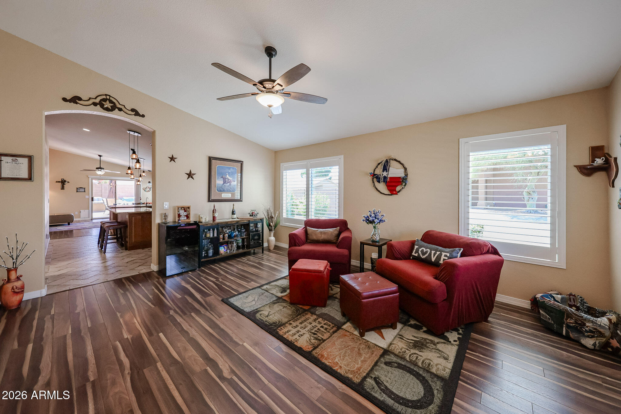 6939 West Phelps Road Peoria, AZ 85382 - Photo 3 of 29 a living room with furniture or couch and a wooden floor