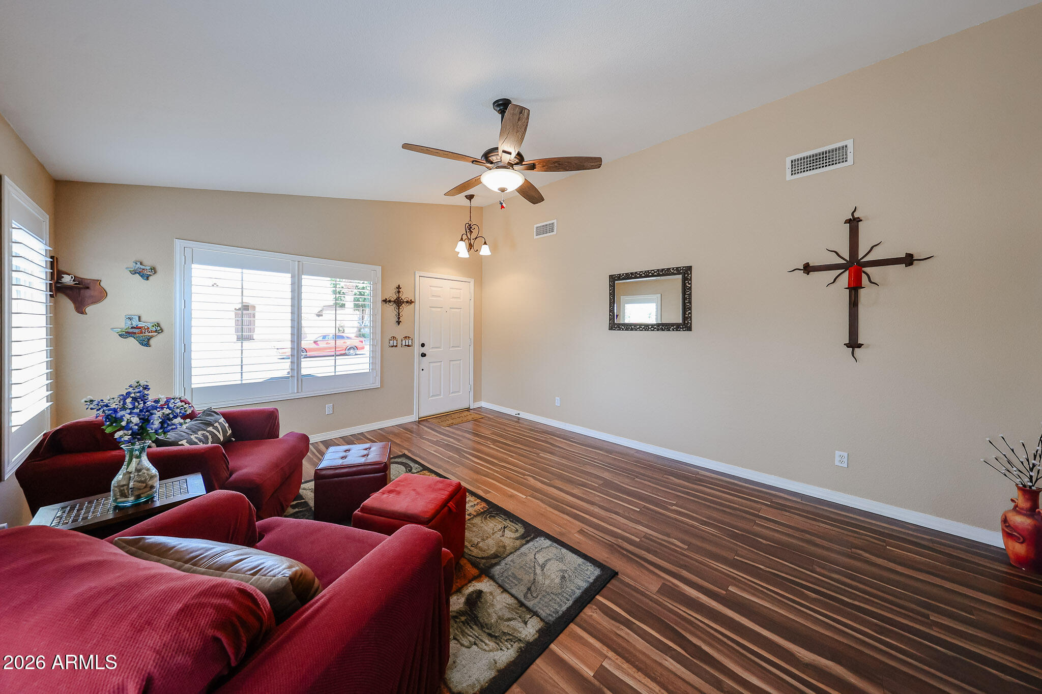 6939 West Phelps Road Peoria, AZ 85382 - Photo 5 of 29 a bedroom with furniture and a window