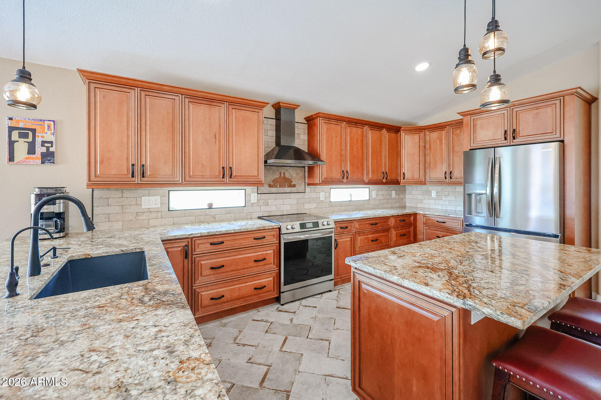 6939 West Phelps Road Peoria, AZ 85382 - Photo 7 of 29 a kitchen with stainless steel appliances granite countertop a stove refrigerator sink and cabinets