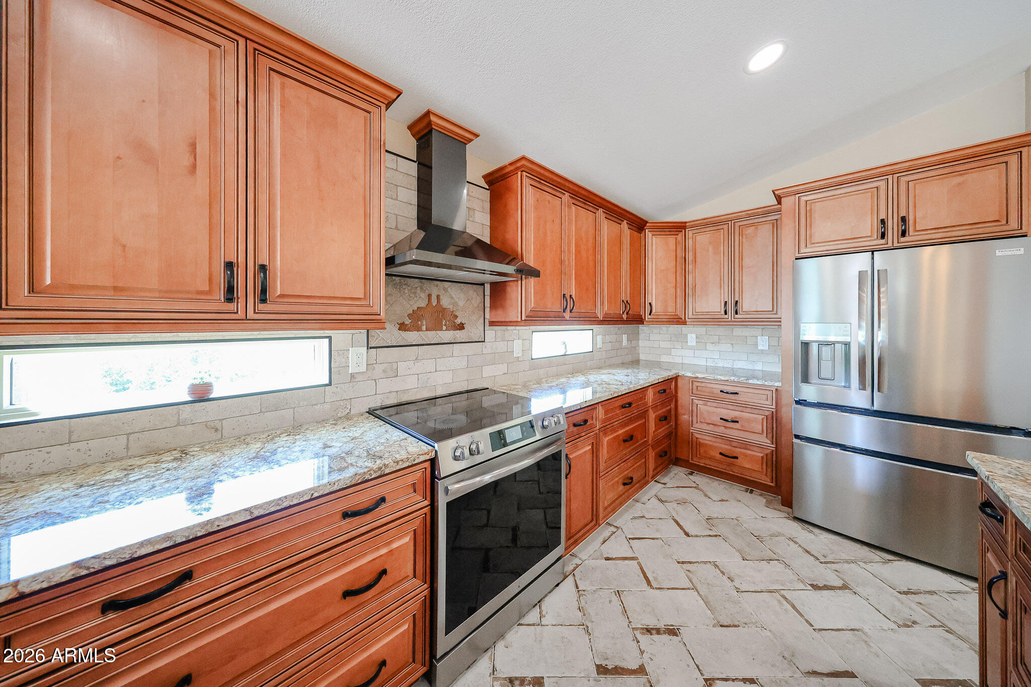 6939 West Phelps Road Peoria, AZ 85382 - Photo 8 of 29 a kitchen with stainless steel appliances granite countertop a refrigerator sink and cabinets