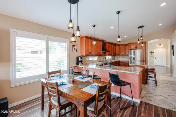 a large kitchen with a table and chairs