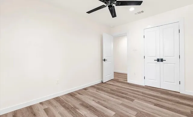 a view of a room with a hardwood and a shower