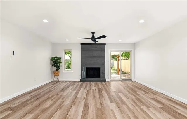 a view of a livingroom with a fireplace and a window
