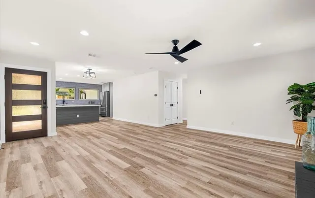 a big room with wooden floor and windows