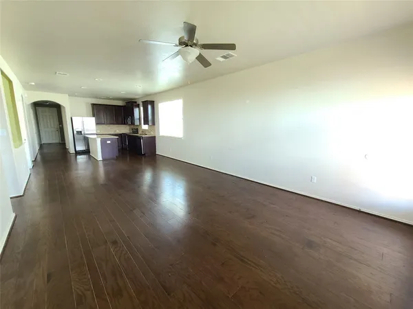 a view of empty room with wooden floor and fireplace