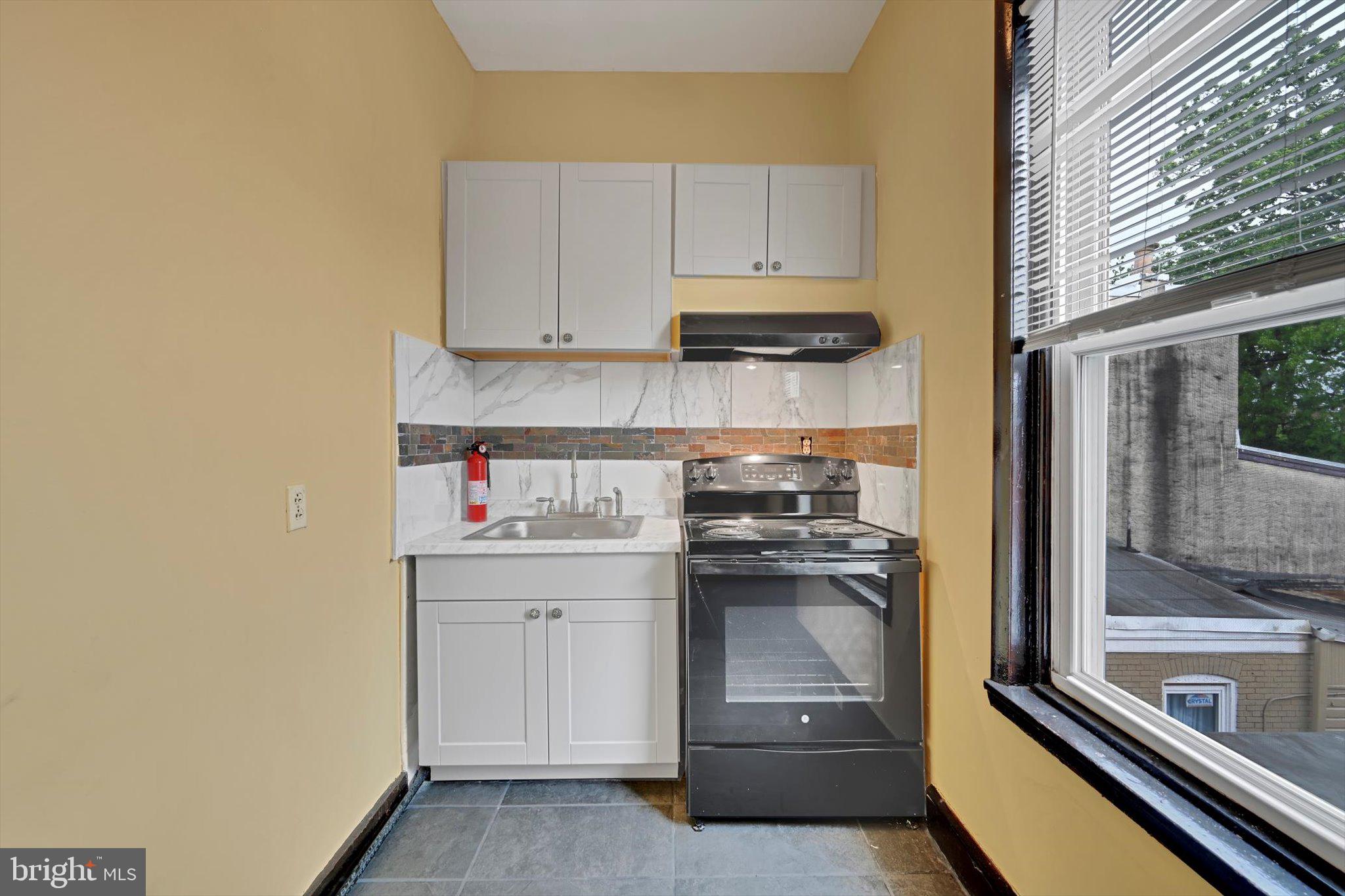 226 South 5th Street Reading, PA 19602 - Photo 16 of 47 a kitchen with a sink and cabinets