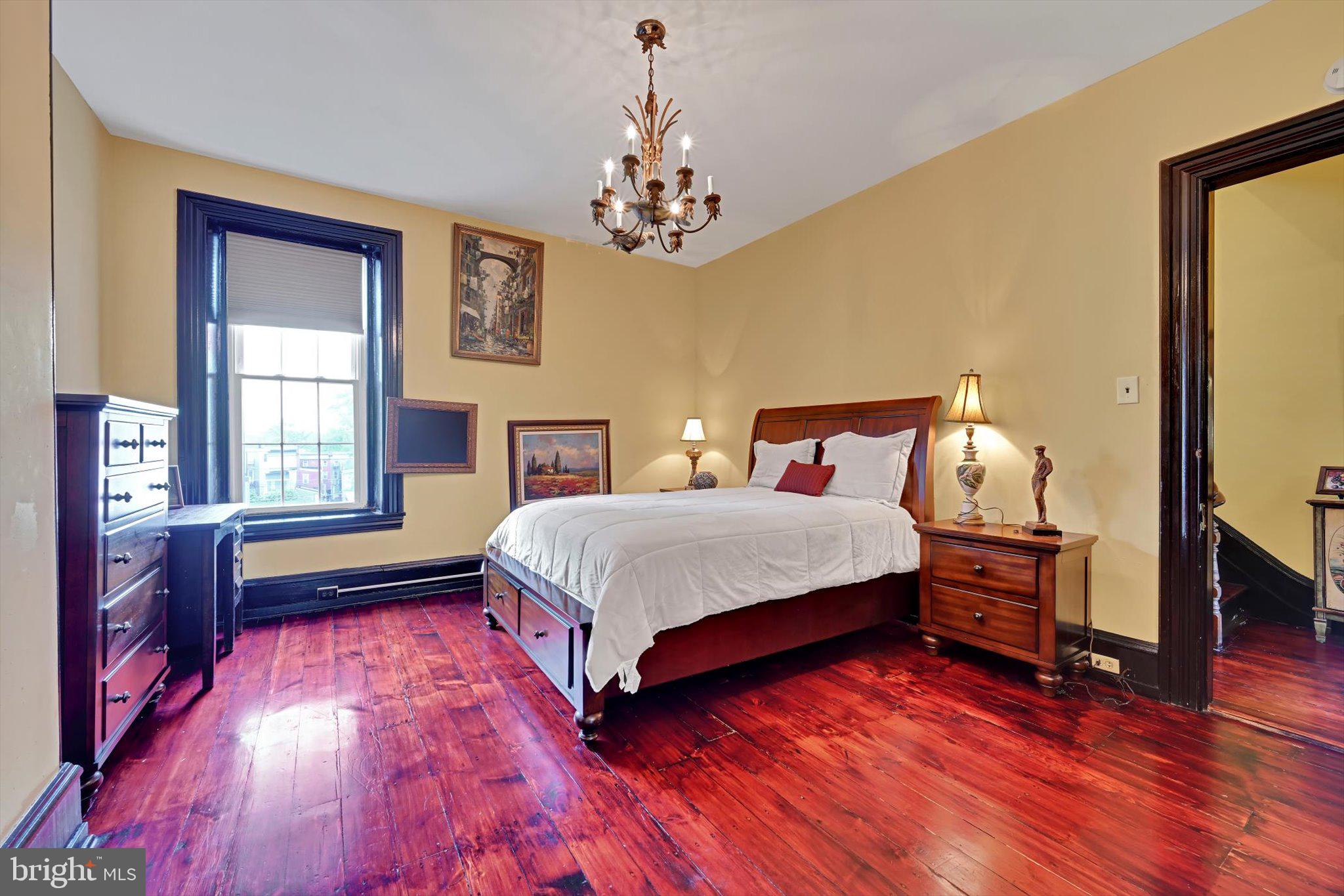 226 South 5th Street Reading, PA 19602 - Photo 26 of 47 a spacious bedroom with a bed and wooden floor