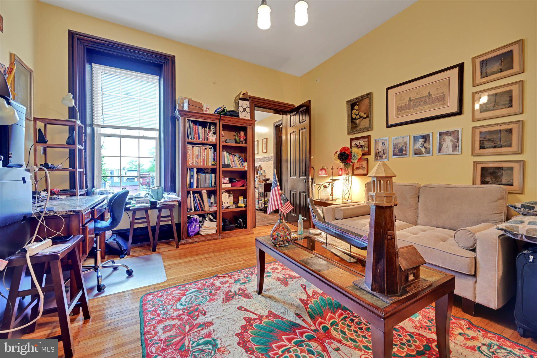 226 South 5th Street Reading, PA 19602 - Photo 29 of 47 a living room with furniture a bookshelf and a window
