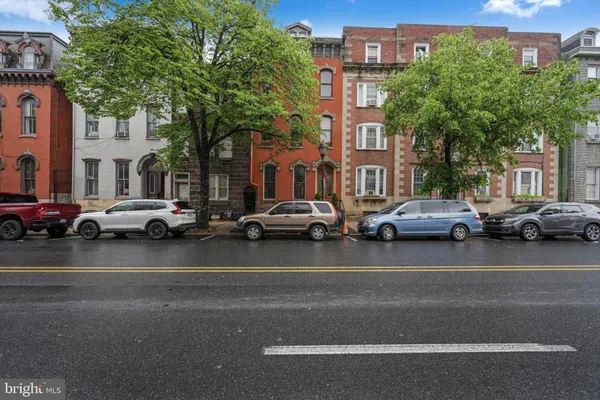 a city street lined with buildings and cars