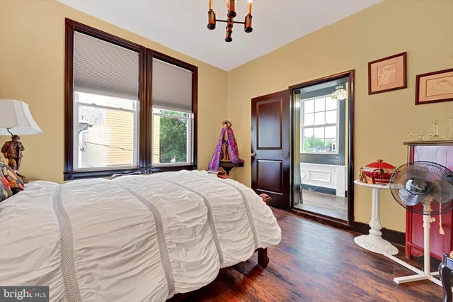 a view of a hallway view with wooden floor and staircase