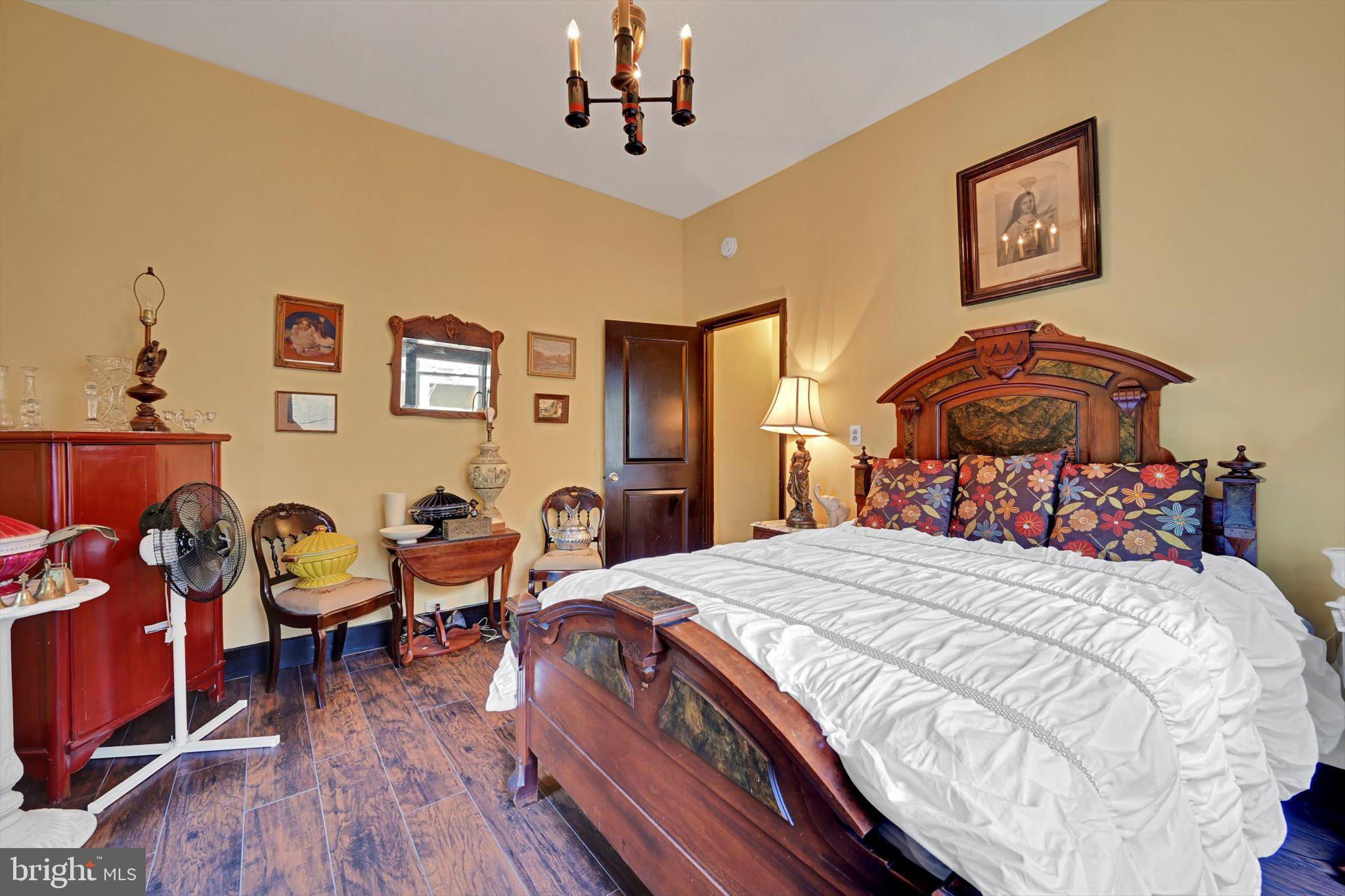 226 South 5th Street Reading, PA 19602 - Photo 33 of 47 a bedroom with a bed and wooden floor