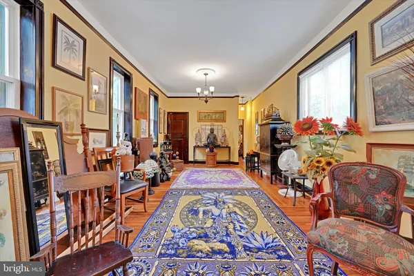 a balcony with chairs and wooden floor
