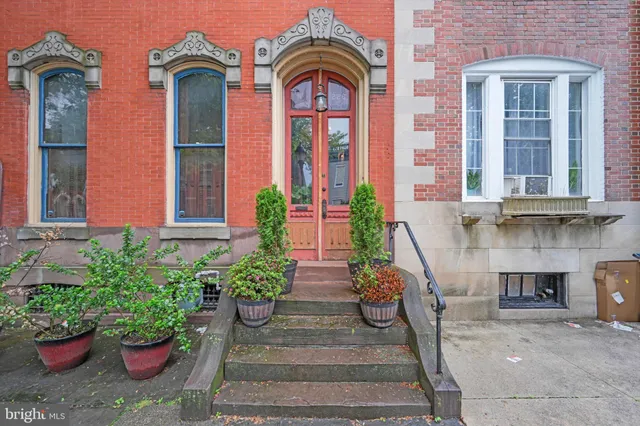 a front view of a building with a yard