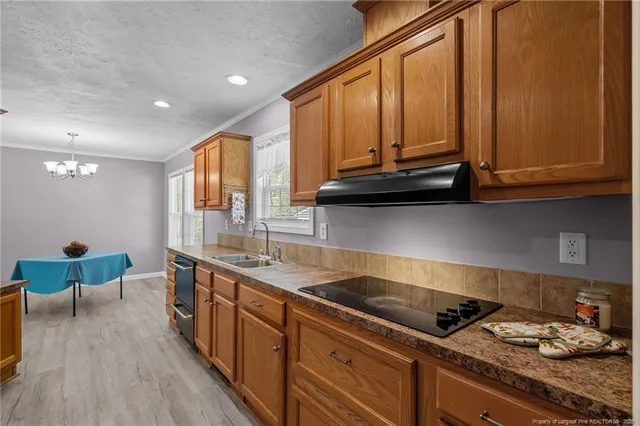 a kitchen with stainless steel appliances granite countertop a sink stove and cabinets