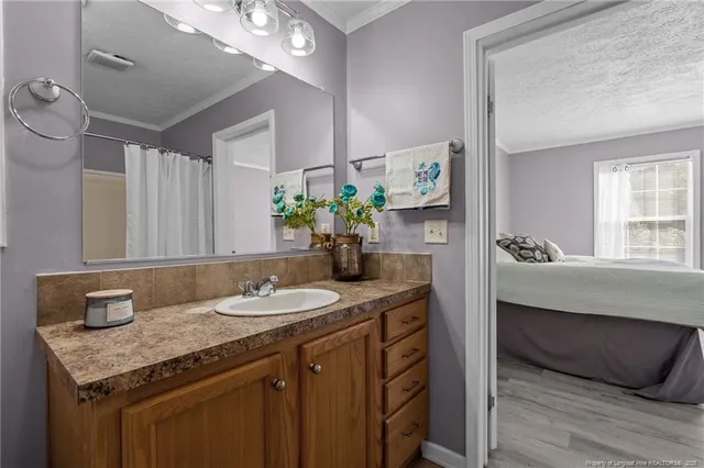 a bathroom with a granite countertop sink a toilet and a mirror