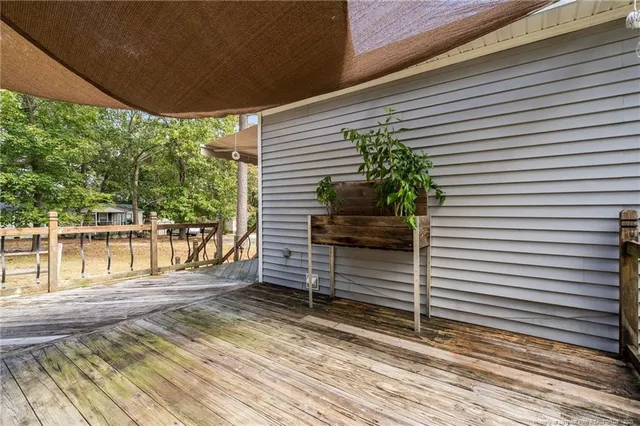 a view of a balcony with wooden floor and fence