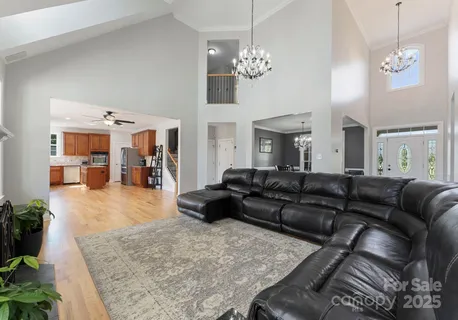a living room with furniture and a chandelier