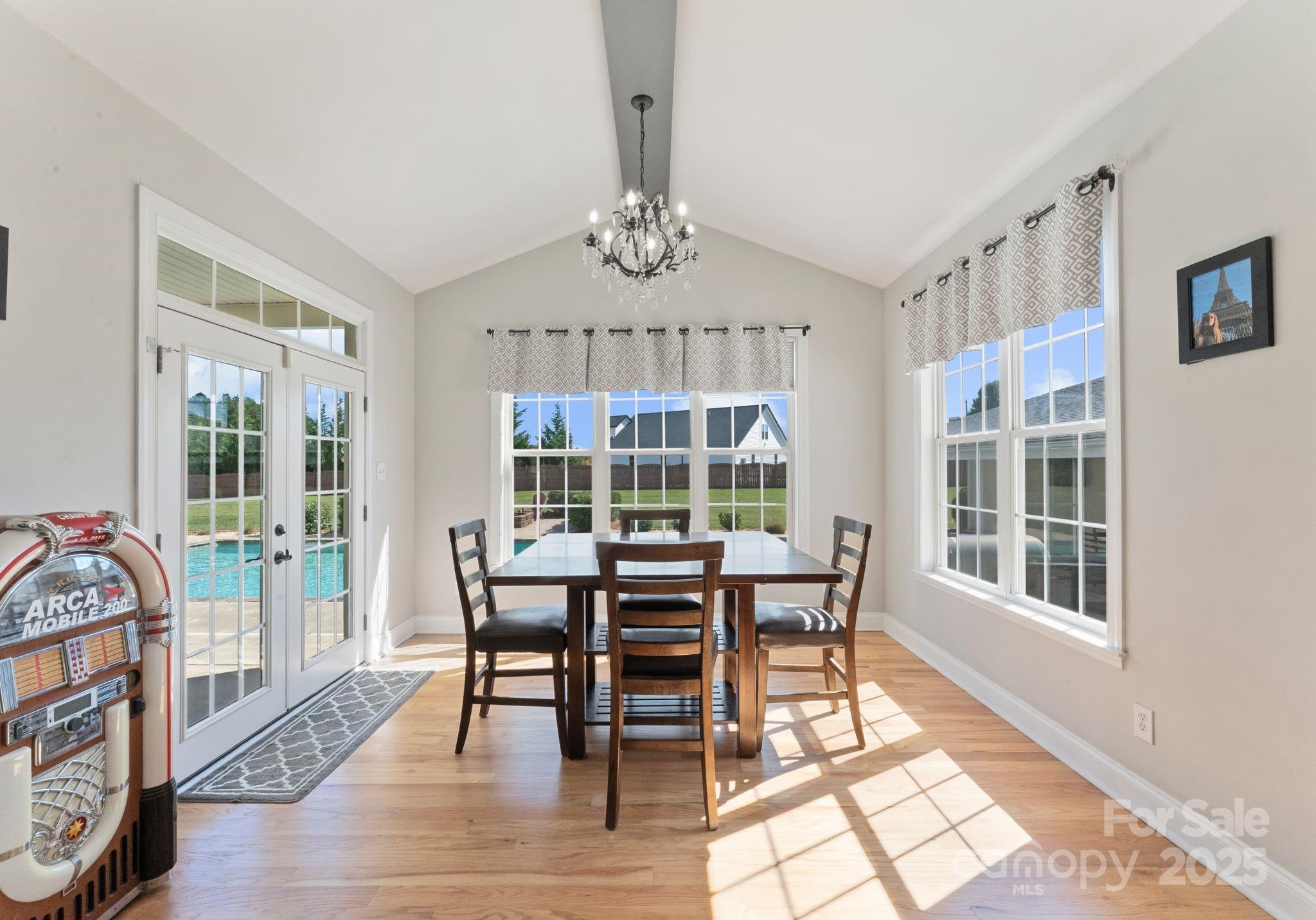 895 East Monbo Road Statesville, NC 28677 - Photo 21 of 44 a view of a dining room with furniture wooden floor and chandelier