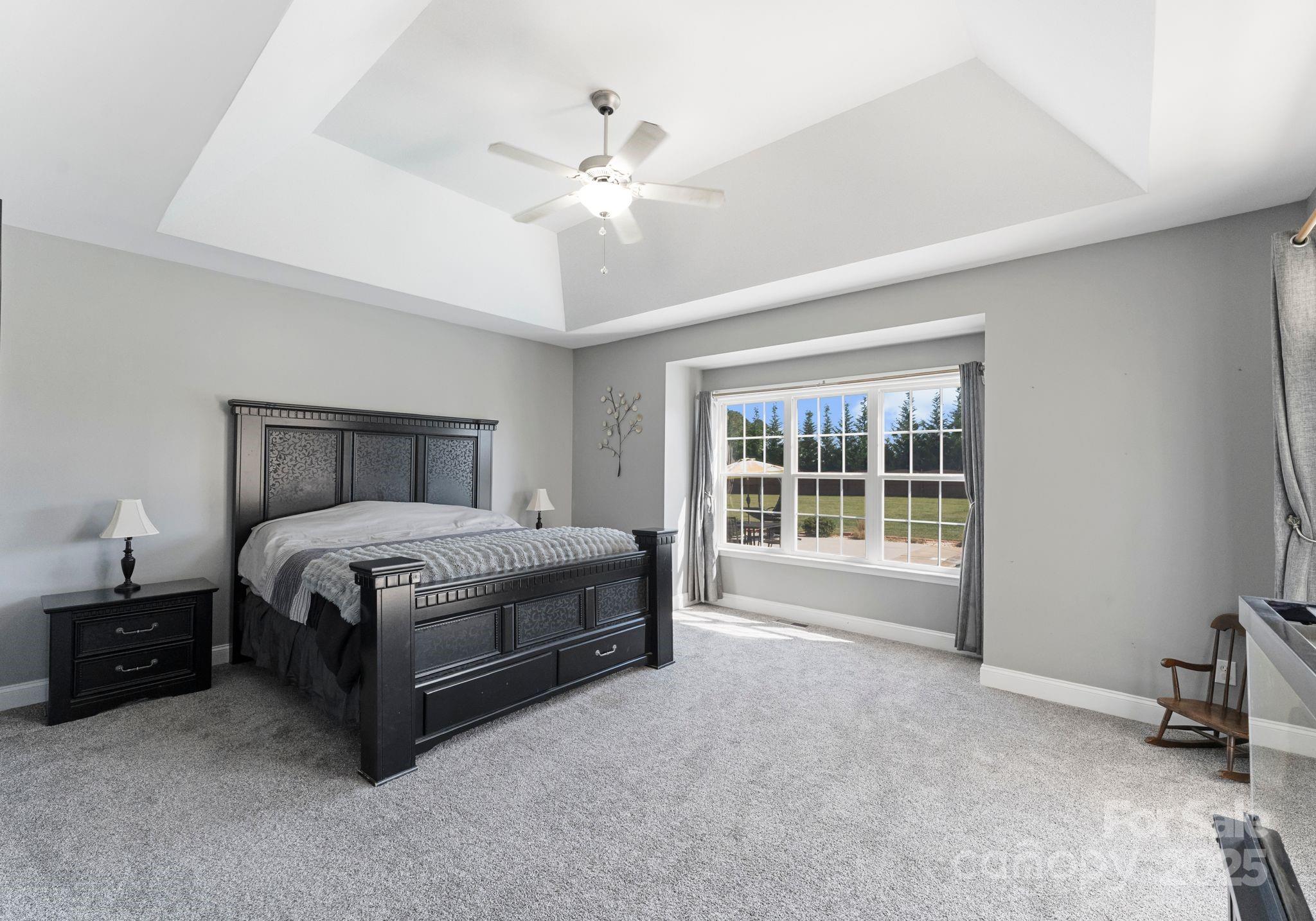 895 East Monbo Road Statesville, NC 28677 - Photo 22 of 44 a spacious bedroom with a bed and a window