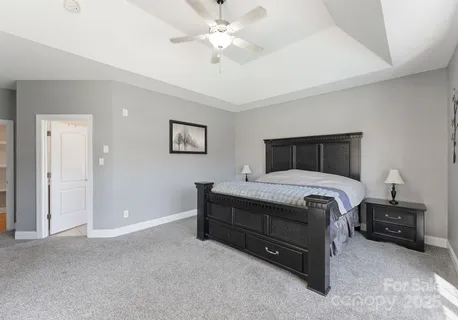 a bedroom with a bed and a ceiling fan