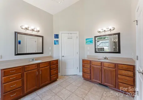 a spacious bathroom with a granite countertop sink and a mirror
