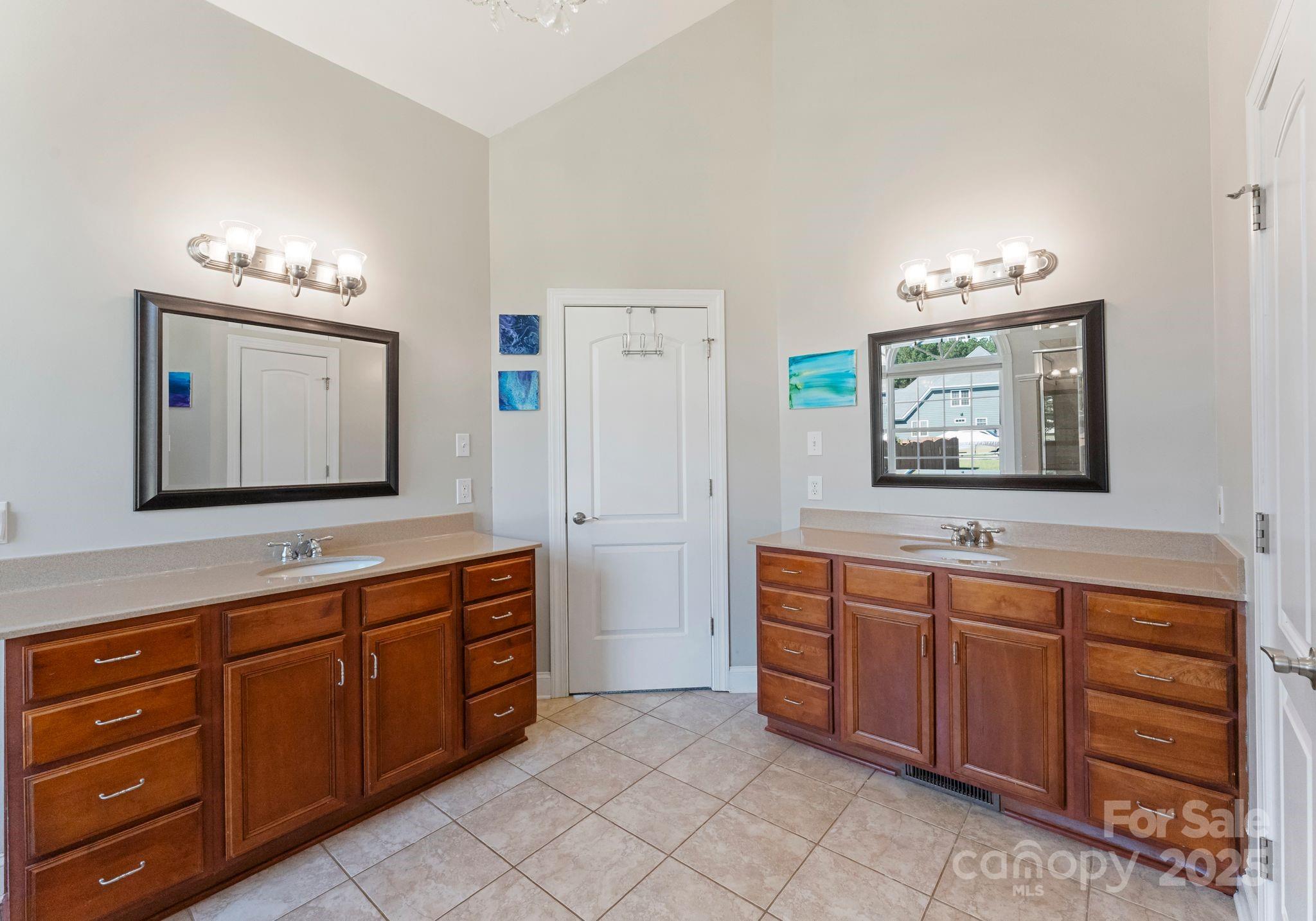 895 East Monbo Road Statesville, NC 28677 - Photo 25 of 44 a spacious bathroom with a granite countertop sink and a mirror