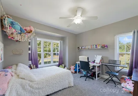 a bedroom with a bed and a desk