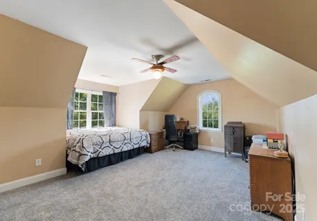 a spacious bedroom with a bed and a large window