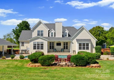 a view of house with outdoor space and sitting area