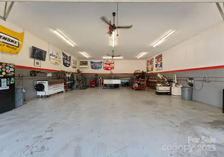 a garage with a flat screen tv and kitchen view