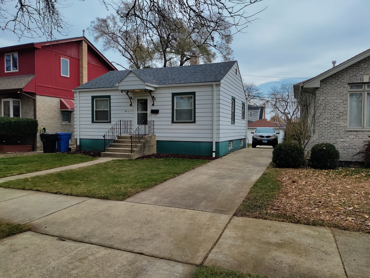 a front view of a house with a yard and a garage