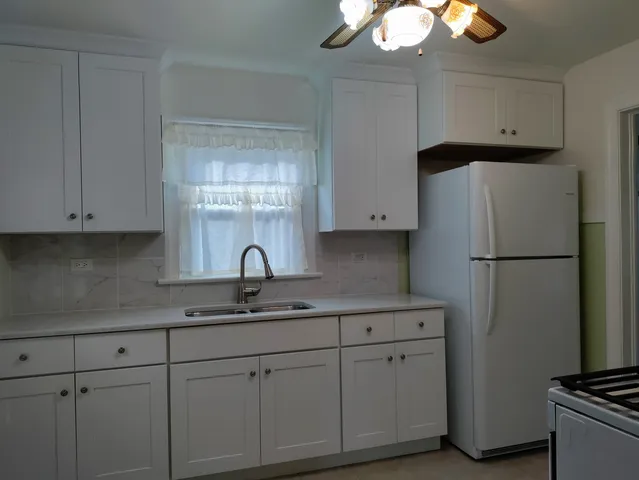 a kitchen with cabinets appliances and a counter space