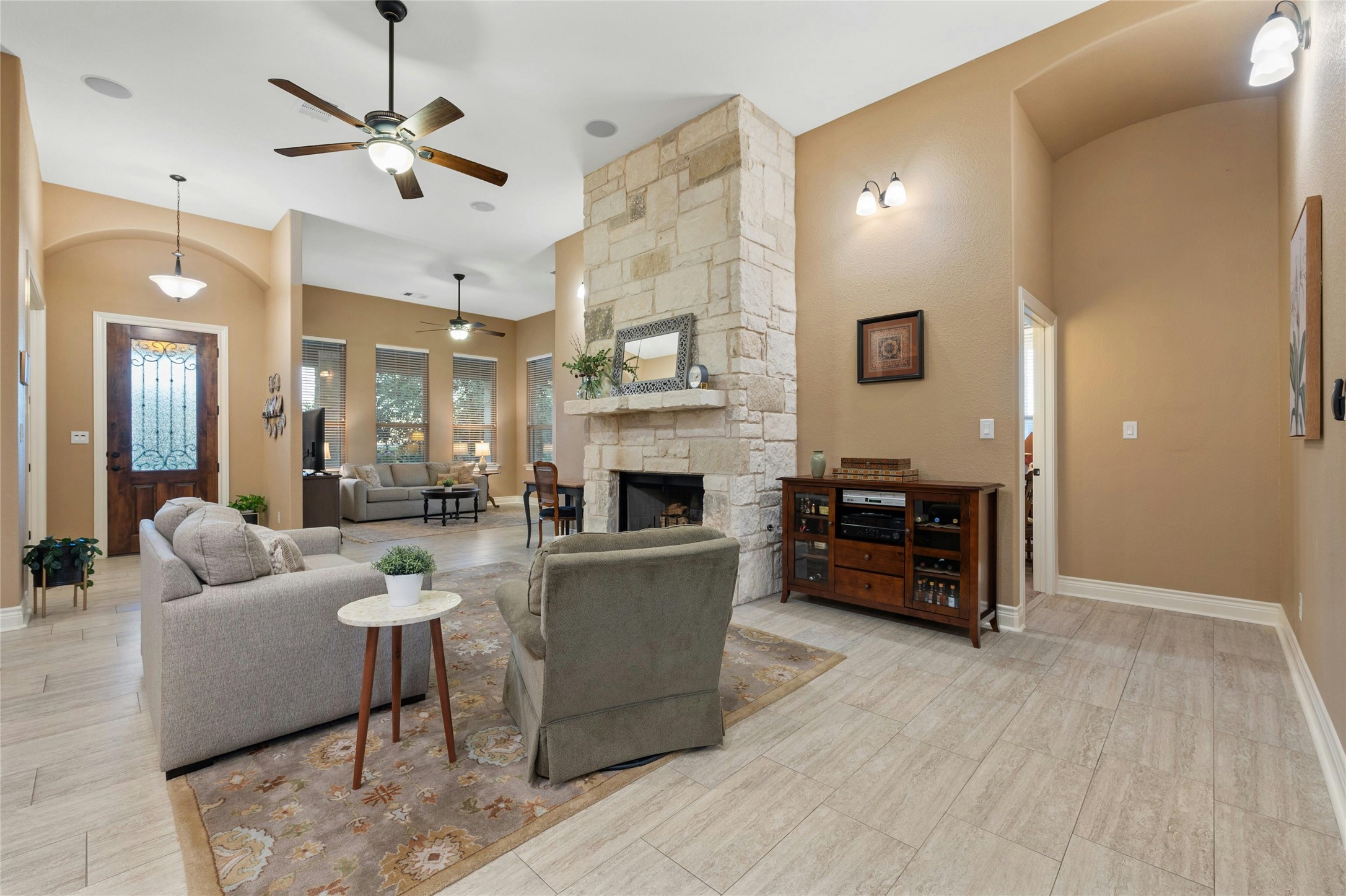 201 Greenridge Lane Dripping Springs, TX 78620 - Photo 8 of 19 a living room with furniture a fireplace and a flat screen tv
