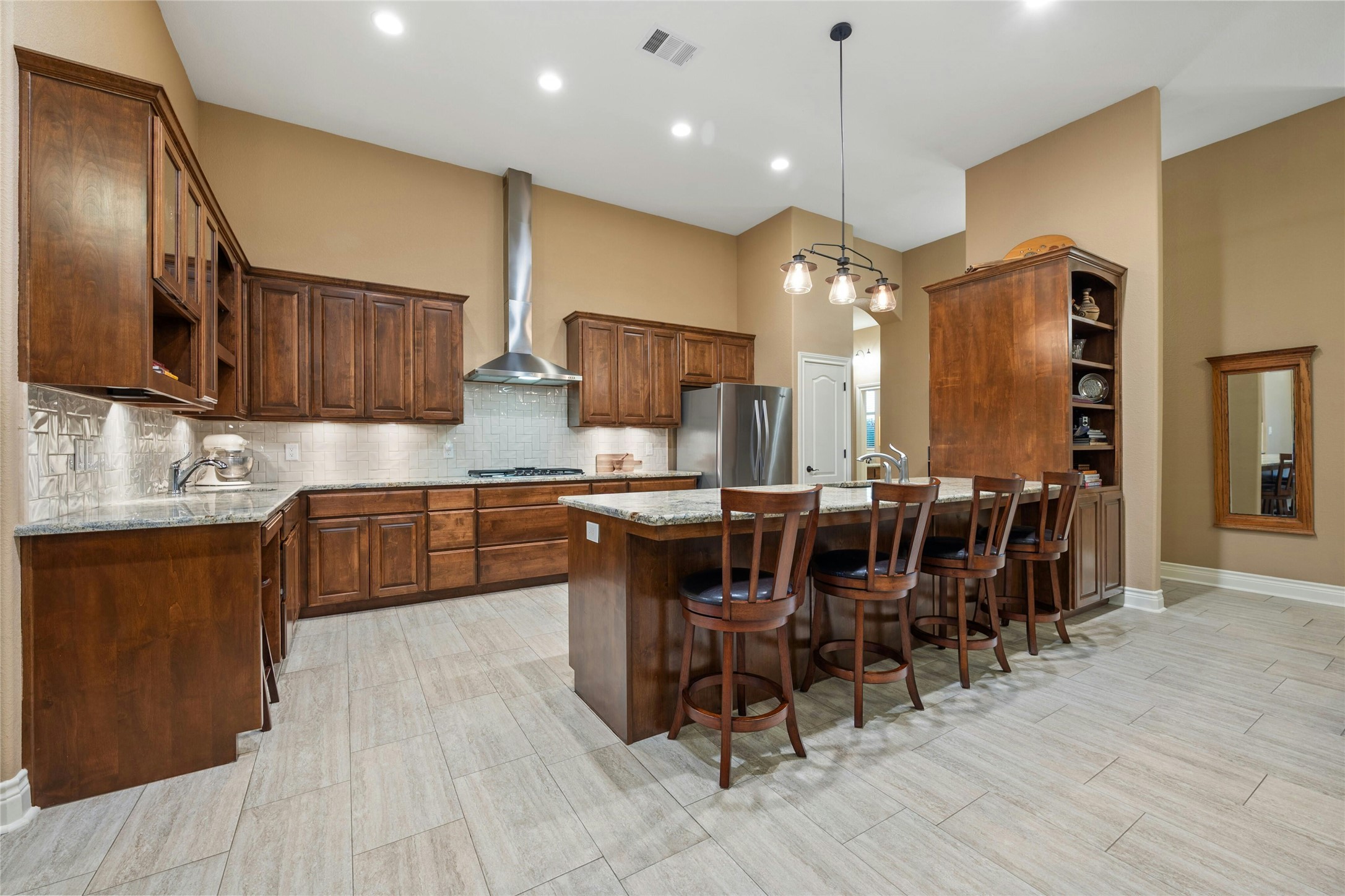 201 Greenridge Lane Dripping Springs, TX 78620 - Photo 10 of 19 a kitchen with stainless steel appliances granite countertop wooden floors stove refrigerator and cabinets