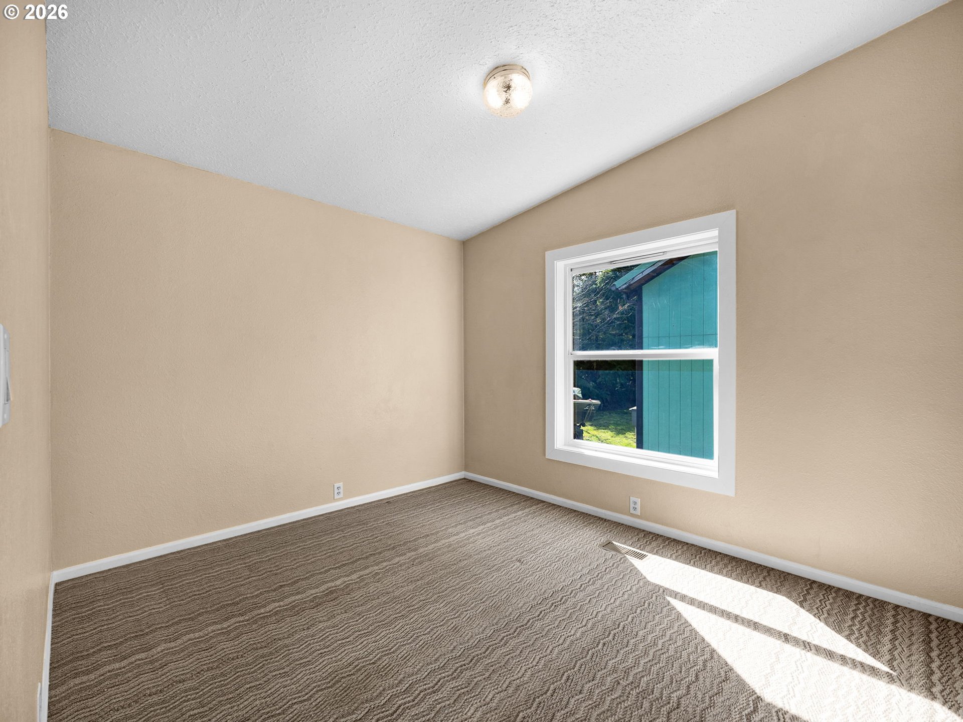 44176 Highway 30 Astoria, OR 97103 - Photo 12 of 32 a view of an empty room with wooden floor and a window