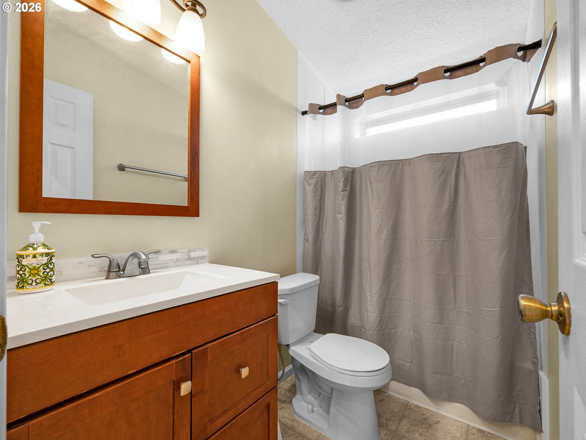 44176 Highway 30 Astoria, OR 97103 - Photo 14 of 32 a bathroom with a sink a toilet and shower