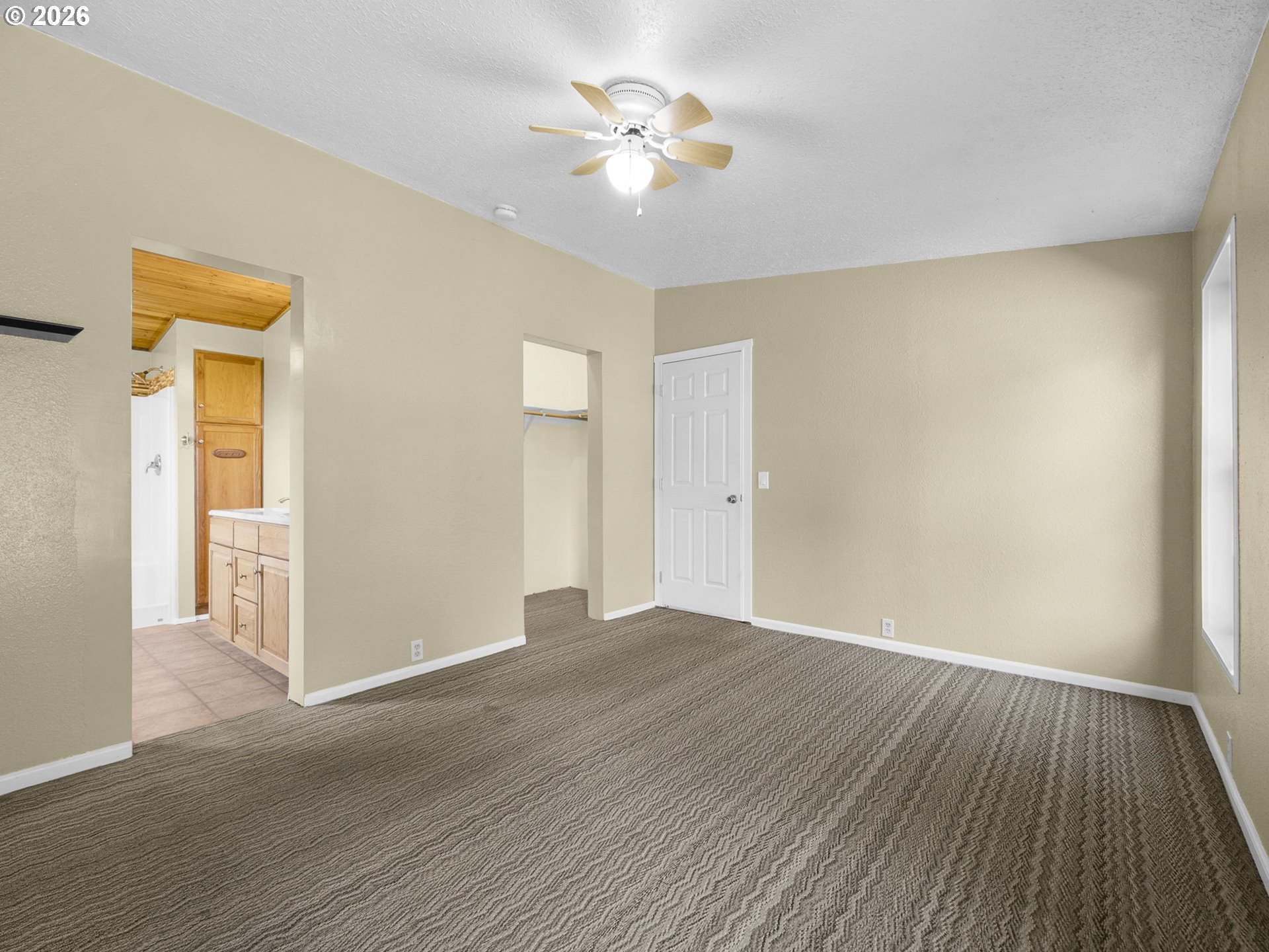44176 Highway 30 Astoria, OR 97103 - Photo 18 of 32 a view of an empty room with chandelier fan and wooden floor
