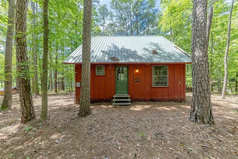 a view of a house with a tree in front of it