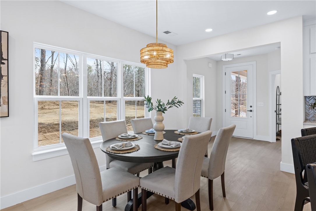 322 Oconee Avenue Westminster, SC 29693 - Photo 5 of 43 This dining area offers abundant natural light and an inviting atmosphere perfect for gatherings.