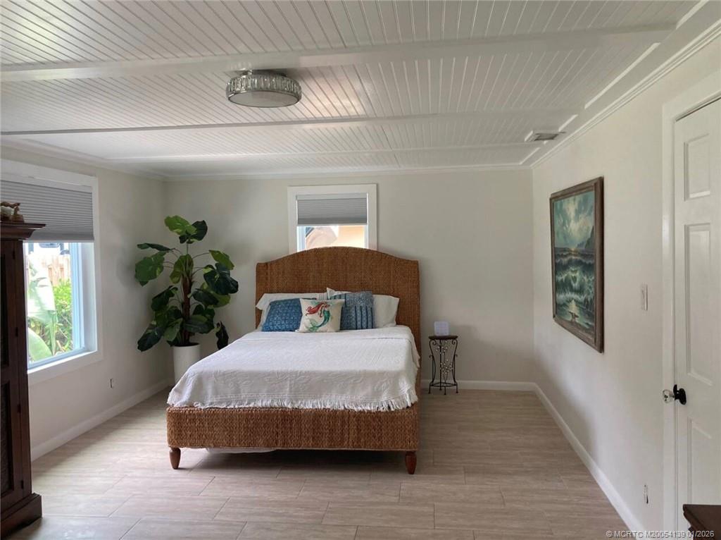 4621 Southeast Shady Ridge Lane Stuart, FL 34997 - Photo 7 of 11 a bedroom with a large bed and a window