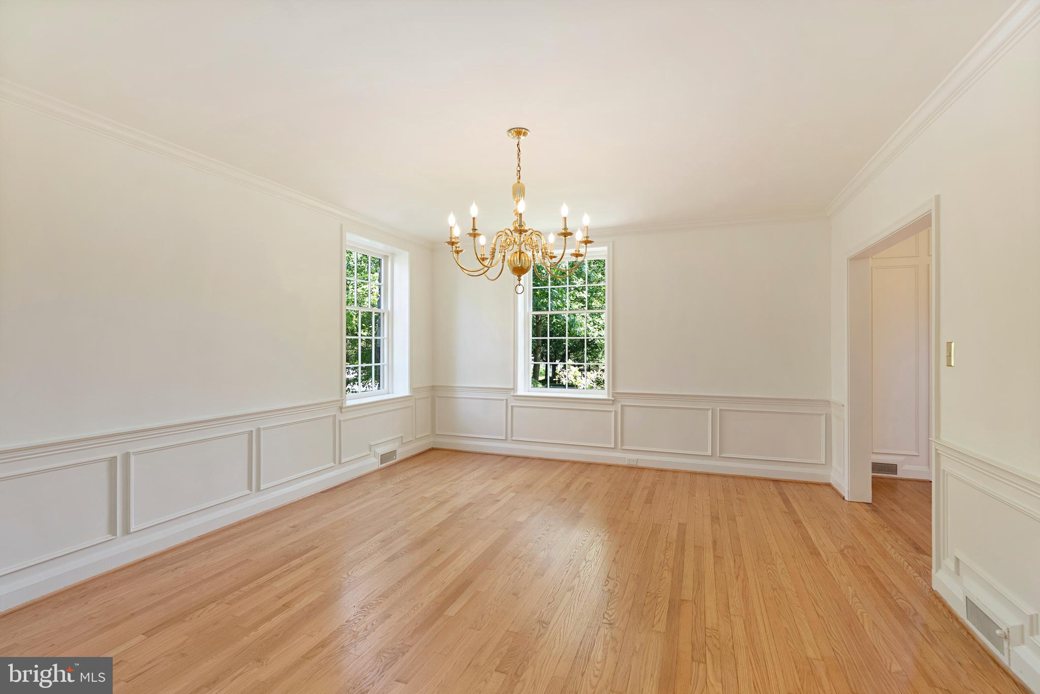 602 Stoneleigh Road Baltimore, MD 21212 - Photo 8 of 31 a view of an empty room with wooden floor and a window