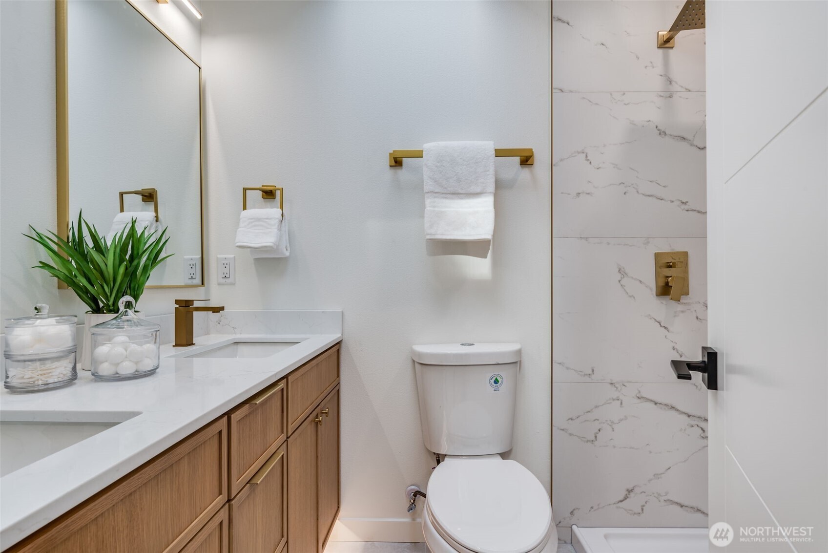4922 Northeast 20th Place Renton, WA 98059 - Photo 11 of 38 a bathroom with a granite countertop toilet a sink and a mirror