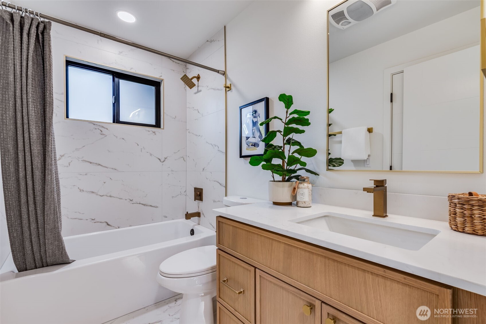 4922 Northeast 20th Place Renton, WA 98059 - Photo 13 of 38 a bathroom with a granite countertop sink a toilet and shower